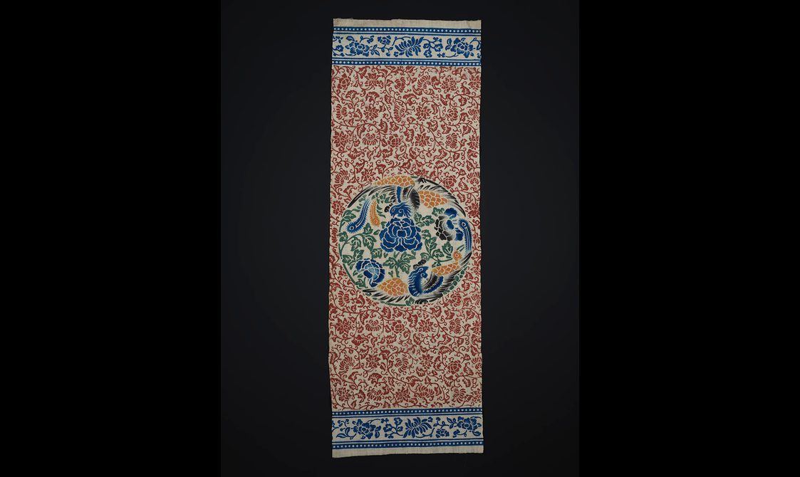 Colourful floral print on cotton in blue, red, green and yellow ink