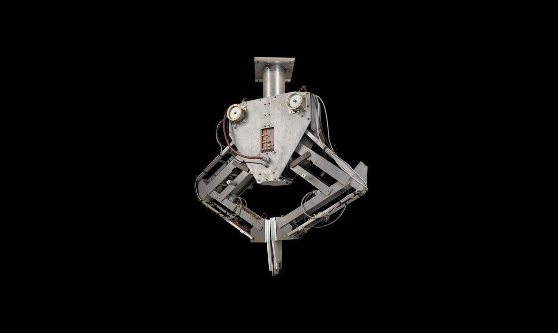 A metal robot with two arms clasped together.